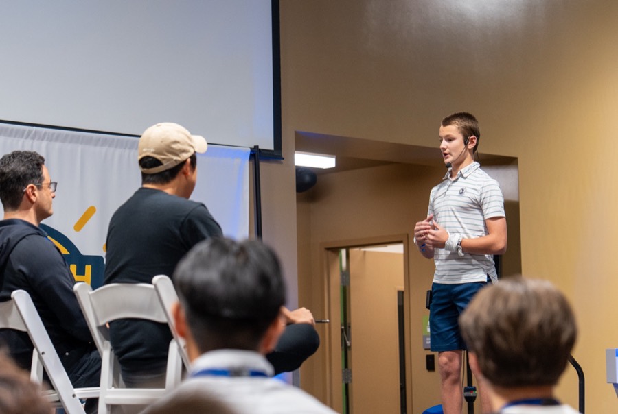Student pitching on stage at the Y.E.S. Summit